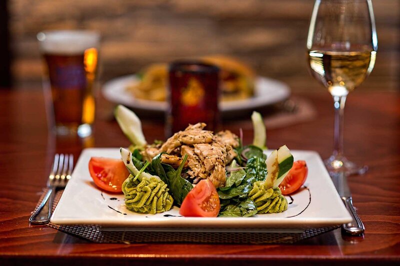 Salad with grilled chicken and glass of white wine